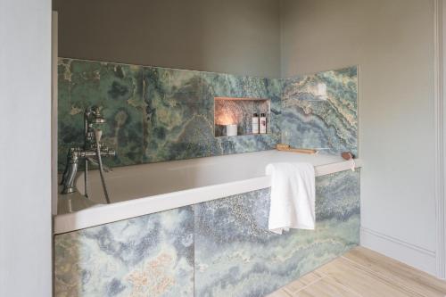 a bathroom with a sink and a mirror on a wall at Reybridge House in Chippenham