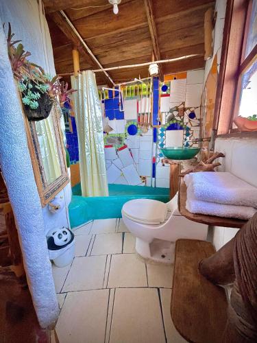 a bathroom with a toilet and a sink at Hotel Casa Tarzan San Agustin in San Agustín