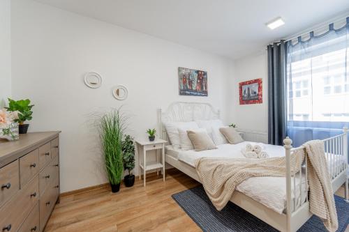 a bedroom with a white bed and a window at Centrum Kosice Apartment 60m2 4 beds in Košice