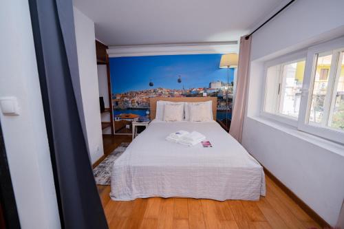 a bedroom with a bed with a view of a city at Large 1-Bedroom 1 Doble bed 1 Sofa bed 1 Bathroom Duplex Apartment Prime Lisbon Location in Lisbon