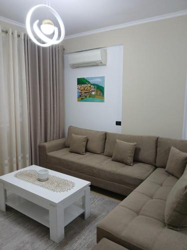 a living room with a couch and a coffee table at Nik's Cozy Apartment in Berat