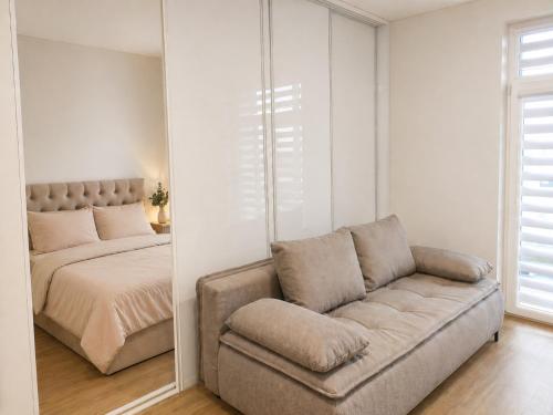 a living room with a couch and a bed at Apartment Ainiai in Panevėžys