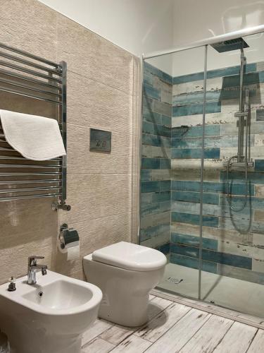 a bathroom with a toilet and a sink and a shower at Naxos Maréa Apartament in Giardini Naxos