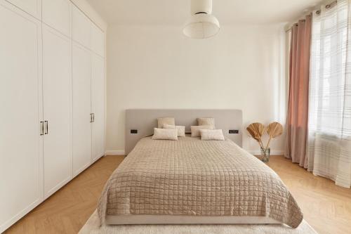 a bedroom with a large bed with white cabinets at Karma Rooms in Ternopil