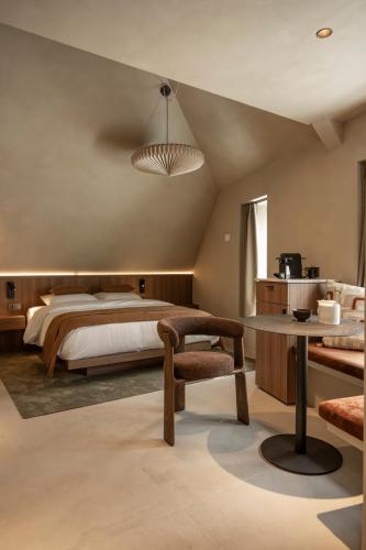 a large bedroom with a bed and a table at Le Diez Boutique Hotel in Den Bosch