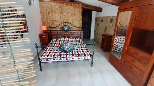 a bedroom with a bed and a mirror at Qui vive un sogno in Roccastrada