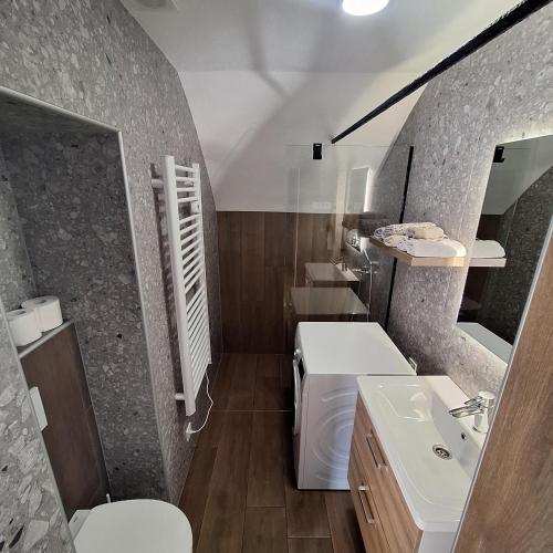 a bathroom with a sink and a toilet at CozyNest in Kamna Gorica