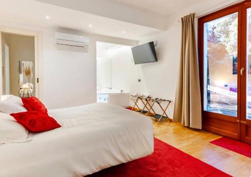 a bedroom with a white bed and a large window at Agri Suite with jacuzzi - La Bilaia in Lavagna