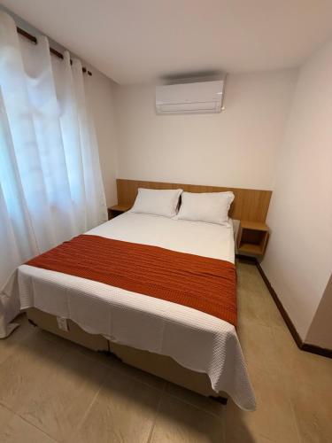 a bedroom with a large bed in a room at Casa da Dinda 202 in Rio das Ostras