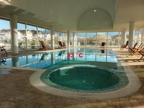 a large swimming pool in a building with a large building at Делта СПА in Banya