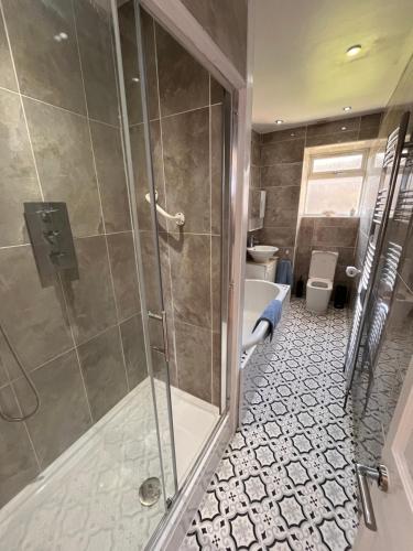 a bathroom with a shower and a toilet at Vistamar Dunoon in Dunoon
