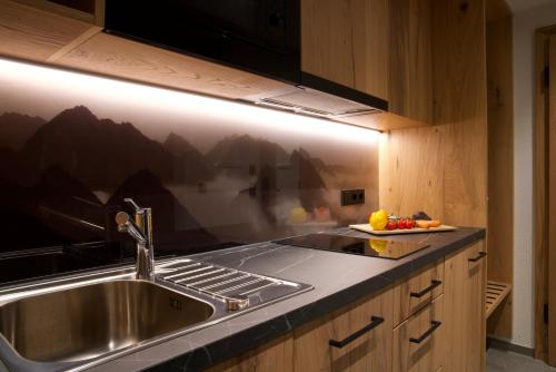 a kitchen with a sink and a counter top at Versalerhof in Ischgl