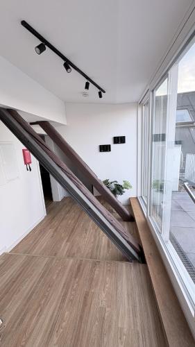 a staircase in a room with a large window at 247 Reside - Apartment SZ3 in Straubing