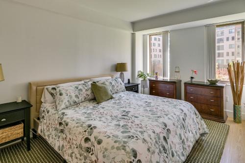 a bedroom with a bed and two dressers and a window at Walk to MIT & T Stop! Kendall Square Extended Base in Cambridge