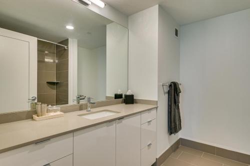 a white bathroom with a sink and a mirror at Walk to MIT & T Stop! Kendall Square Extended Base in Cambridge