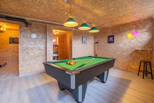 a billiard room with a pool table in it at Gîte de l'Esplanade-18 min du Puy du Foù-Ventilateurs- Billard- Baby-foot-Fléchettes-Grande maison de bourg spacieuse de 200m2- Famille-Amis-Groupe in Pouzauges