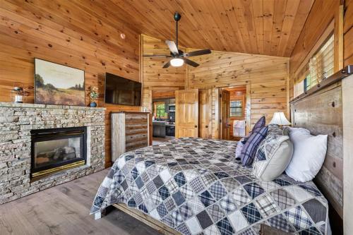 a bedroom with a bed and a fireplace at All About Romance by Venture Smoky Mountains in Henderson Springs