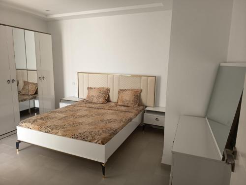 a bedroom with a large bed in a white room at La tulipe d'Hammamet in Hammamet