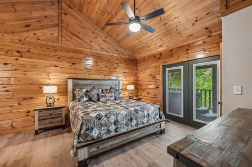 a bedroom with a bed and a ceiling fan at A Hen House by Venture Smoky Mountains in Pigeon Forge
