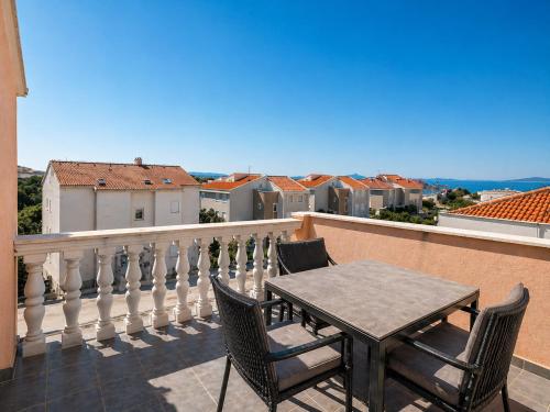 a table and chairs on a balcony with a view at Apartments Peris Resort in Novalja