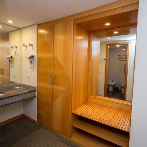 a bathroom with a sink and a mirror at 807 - Hotel & Residence Sol Alphaville Flat in Barueri