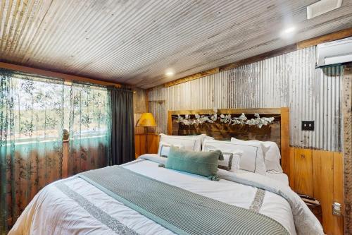 a bedroom with a large bed and a window at Walk to Trails & Fishing Spots! Lake Ozark Escape in Four Seasons