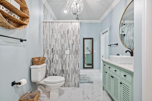 a bathroom with a toilet and a sink and a mirror at Just Beach It! in Port Bolivar