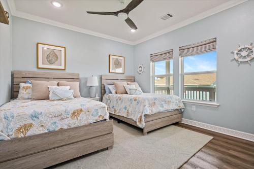 a bedroom with two beds and a window at Just Beach It! in Port Bolivar
