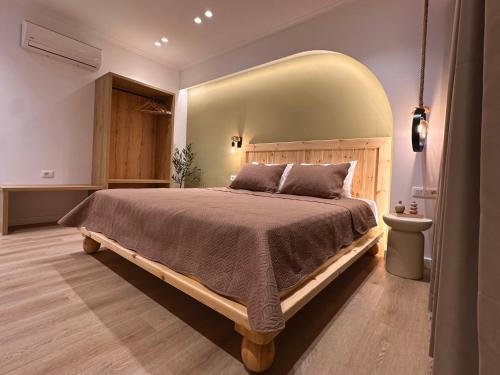 a bedroom with a large bed with a large headboard at Spilea Apartments in Himare