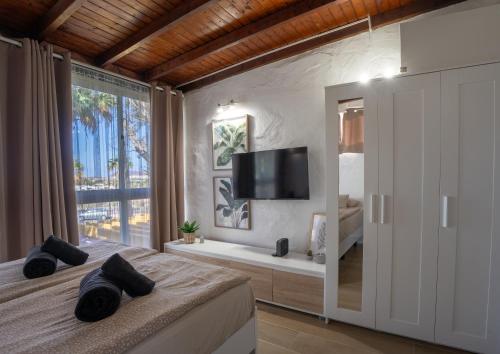 a bedroom with a large bed with a large window at Silent Paradise Drago Complex in Costa Del Silencio