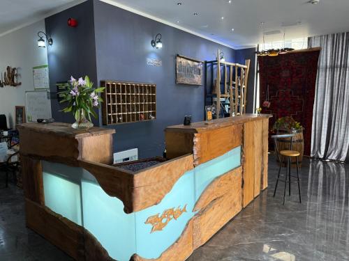 a bar with a fish tank in a room at Hotel AnOrita in Kobuleti