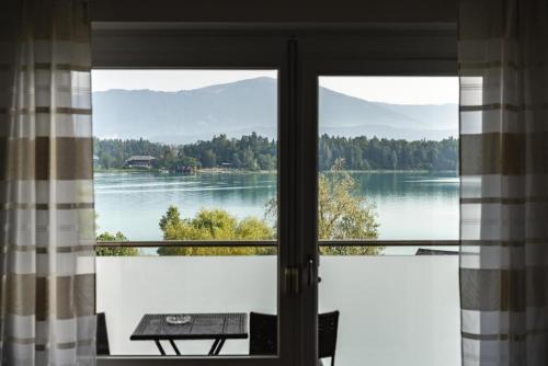 a view of a lake from a window at Faaker See Inn by Aurora in Faak am See