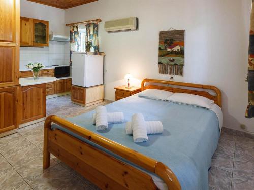 a bedroom with a bed with towels on it at CottonClub Villas in Tolo