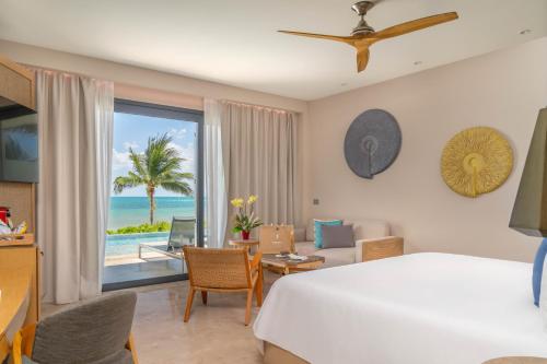 a bedroom with a bed and a view of the ocean at Haven Riviera Cancun - All Inclusive - Adults Only in Cancún