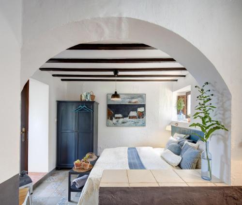 a bedroom with a large bed with a blue door at El Arpa in El Chorro