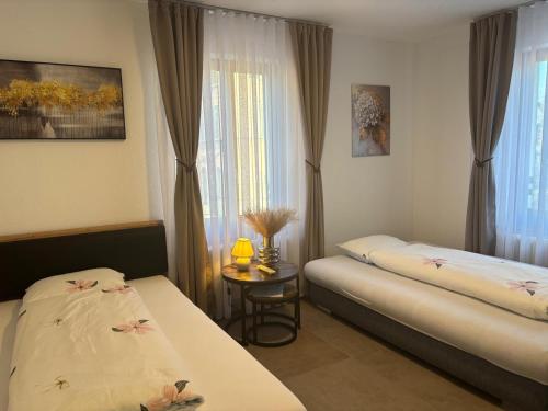 a hotel room with two beds and a window at Bellavista Home 2 in Trimbach