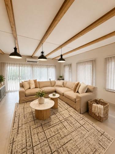 a large living room with a couch and a table at Lenmed Prime Spot in Kimberley