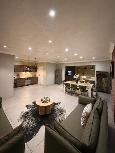 a large living room with a couch and a table at Lenmed Prime Spot in Kimberley
