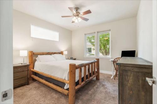 a bedroom with a bed and a ceiling fan at Schweitzer & Dover Bay - Ski Lake Dine in Dover