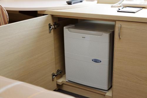 a computer system in a cabinet under a desk at Hotel Monte Hermana Kobe Amalie in Kobe