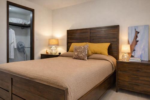 a bedroom with a large bed and two lamps at Panoramic Oceanfront Resort Style Condo in Rosarito