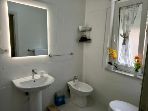 a bathroom with a sink and a toilet and a mirror at Umberto I in Nicosia