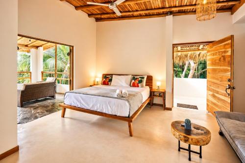 a bedroom with a bed and a couch at Villa Ananda in Mal País