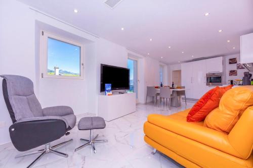 a living room with a yellow couch and chairs at Yellow View Apartment - Ronco S Ascona - Happy Rentals in Ronco sopra Ascona