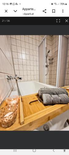 a bathroom with a wooden cutting board and a bath tub at Apartment Andras in Murau