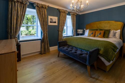 a bedroom with a bed and a blue wall at Boyne View House in Trim