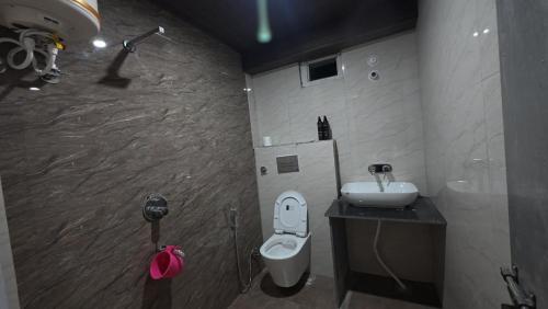a bathroom with a toilet and a sink at Harsil River Retreat in Harsil