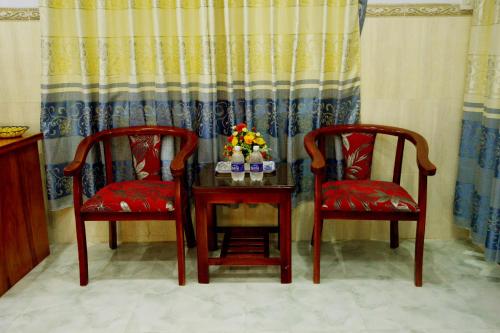 two chairs and a table with two drinks on it at Vien Duong Hotel in Quy Nhon