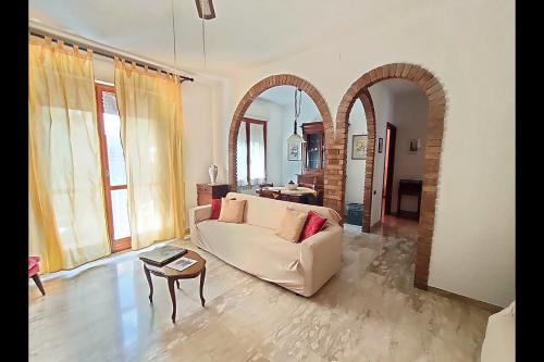 a living room with a couch and a table at I Tre Archi in Suvereto
