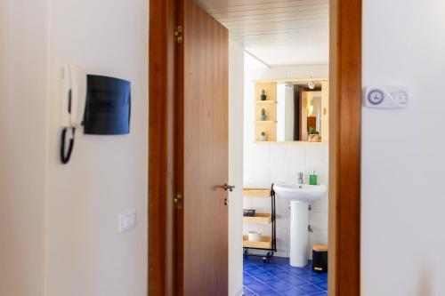 a bathroom with a sink and a toilet and a mirror at Ria Apartment in Le Grazie